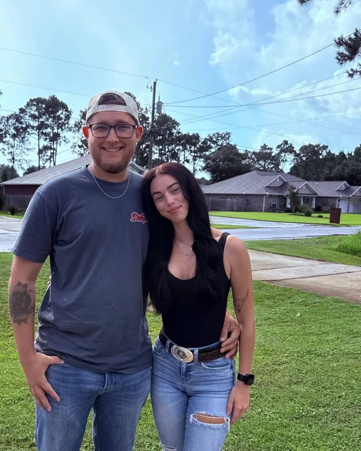 Mason and Tarah, the owners of Slaughter Property Experts, standing on a lawn in Navarre